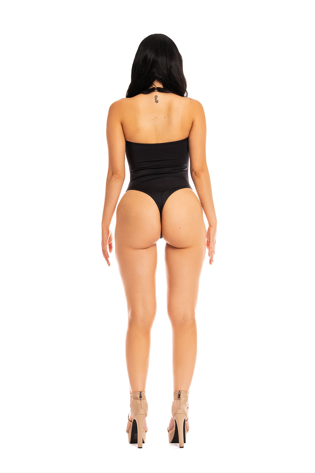 Model wearing the Cayena monokini with strategic cutouts and Brazilian thong back.